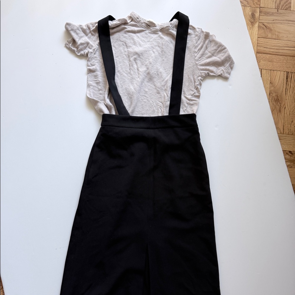 A-line skirt with detachable suspenders. Slit in the front